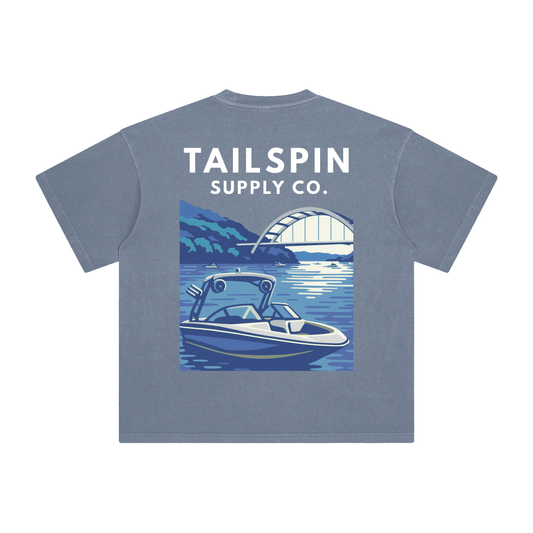Blue t-shirt with 'Tailspin Supply Co.' logo and boat graphic on a white background